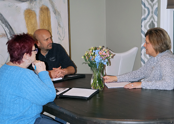 Executive director of St. Raymond's Society, Mike Hentges, discusses future plans with Dorreen Rardin and Jackie Reed of Caring Hearts and Hands of Columbia