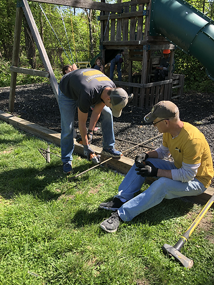 Two men saw rebar 